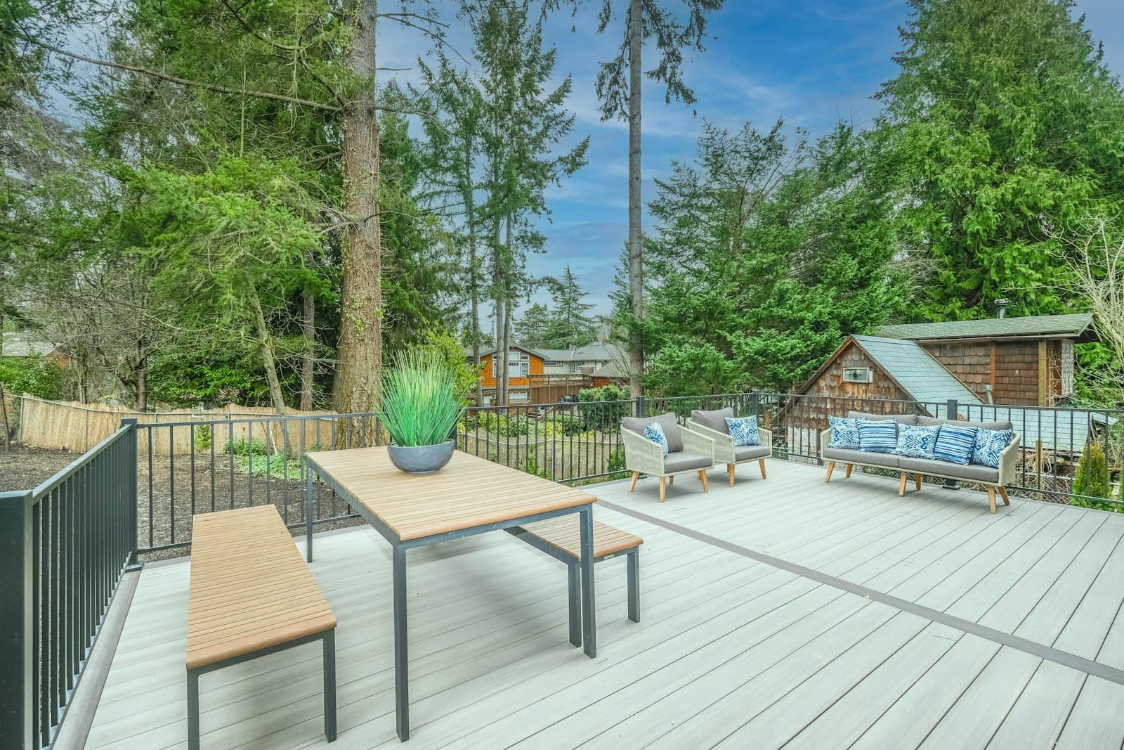 Traditional brown cedar deck with wooden patio table and chairs — the warm-toned hardwood detailing that reads right on a Toronto pre-war house.