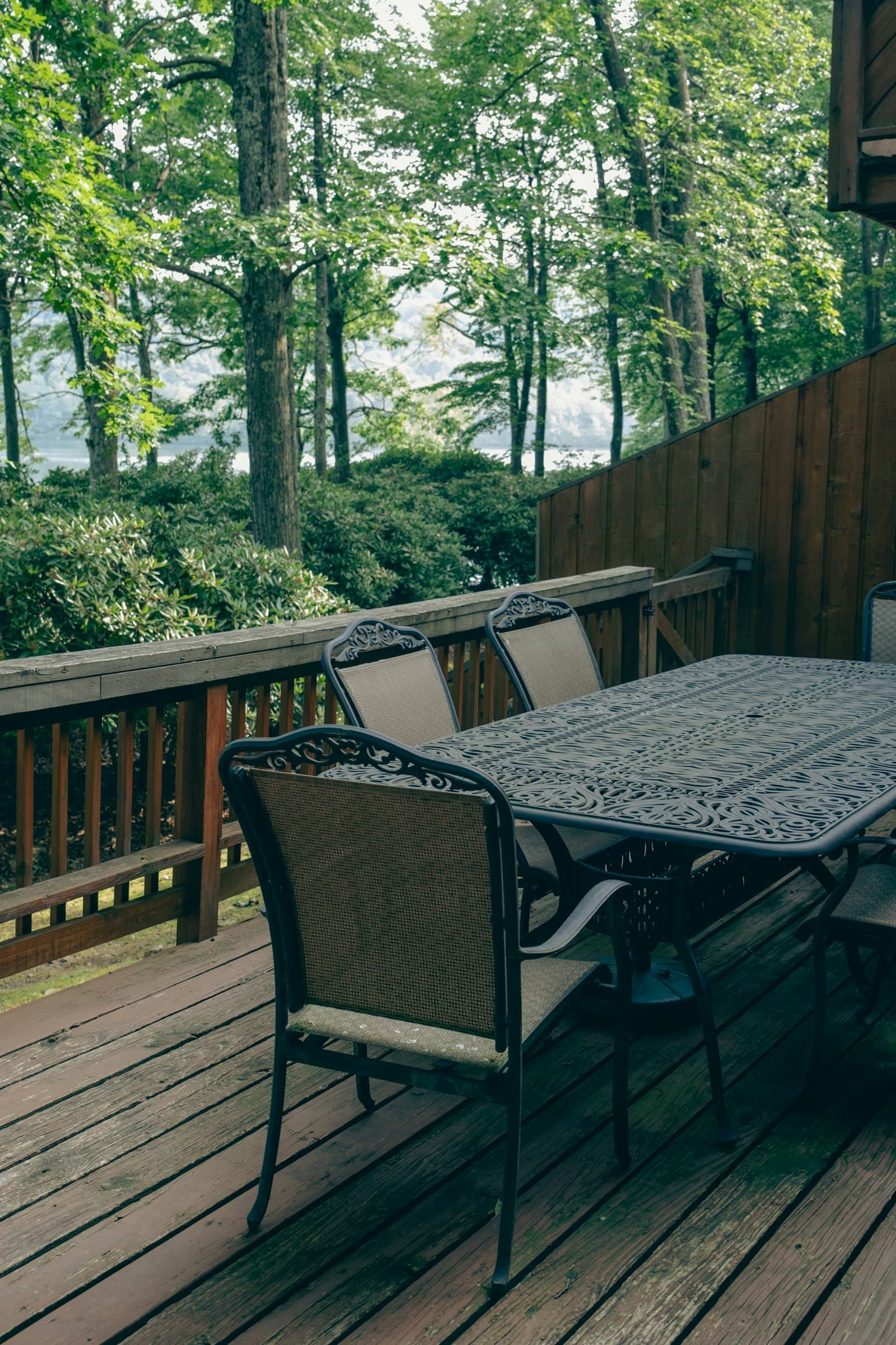 A small cedar deck with a wooden table and two chairs — the kind of intimate backyard build Toronto cedar pricing commonly quotes against.