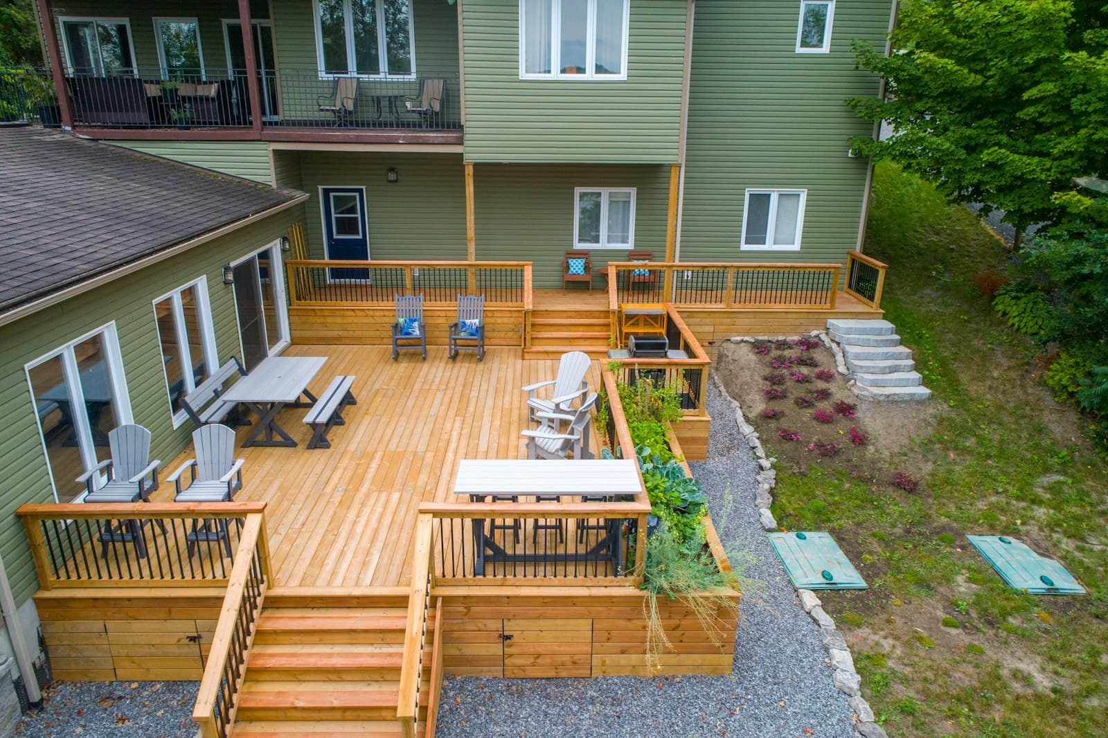 A finished composite deck with patio furniture next to a residential GTA home — the typical mid-range install priced through the calculator on this site.